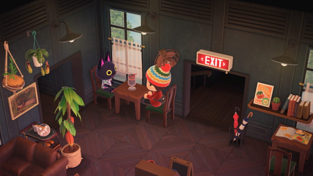 A screenshot from Animal Crossing: New Horizons. A human character wearing a striped winter hat sits at a cafe table with a black cat character.